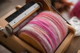 Blending fibers with a drum carder